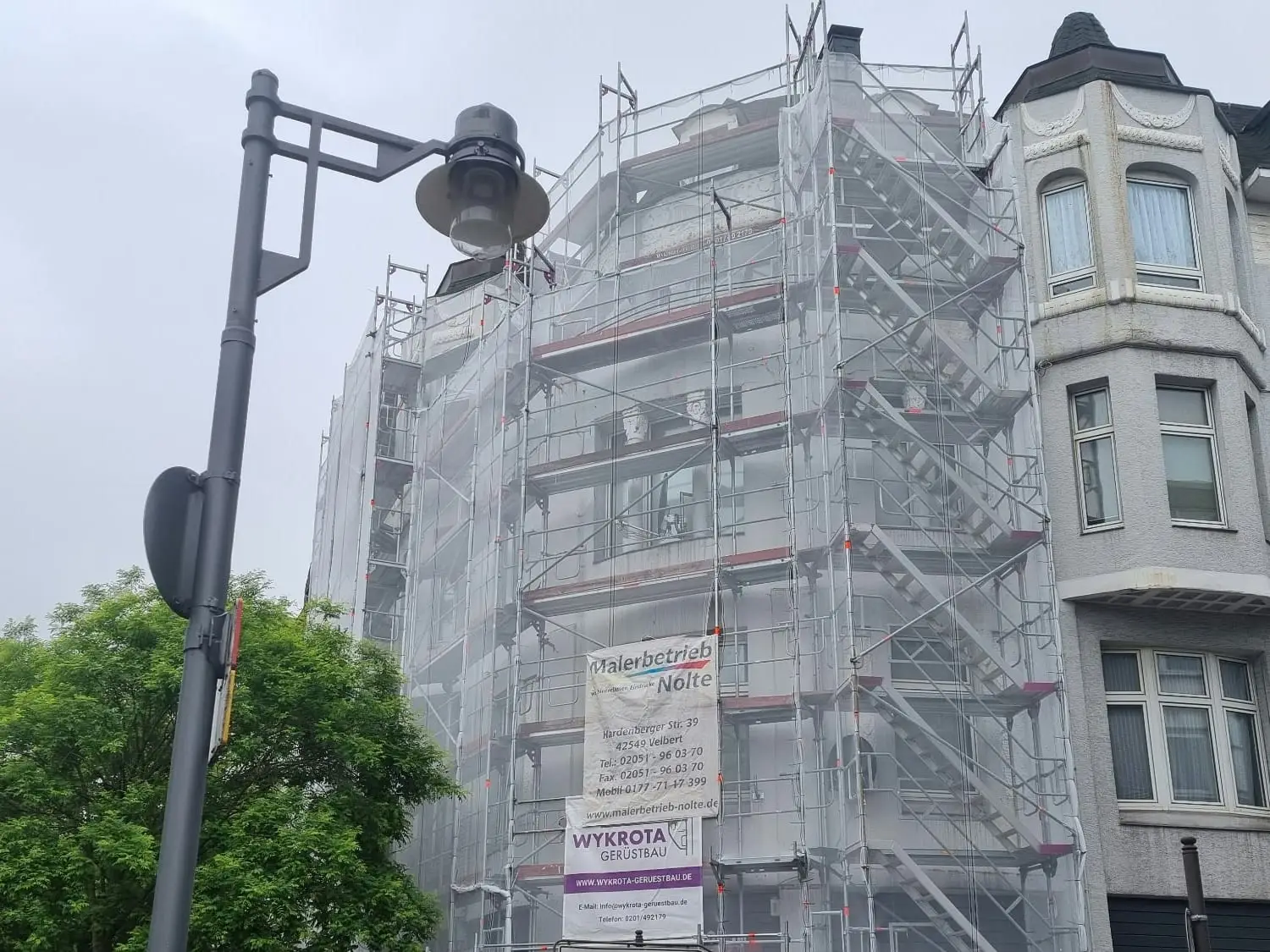 Das Eckhaus komplett eingerüstet und mit Netz verhängt